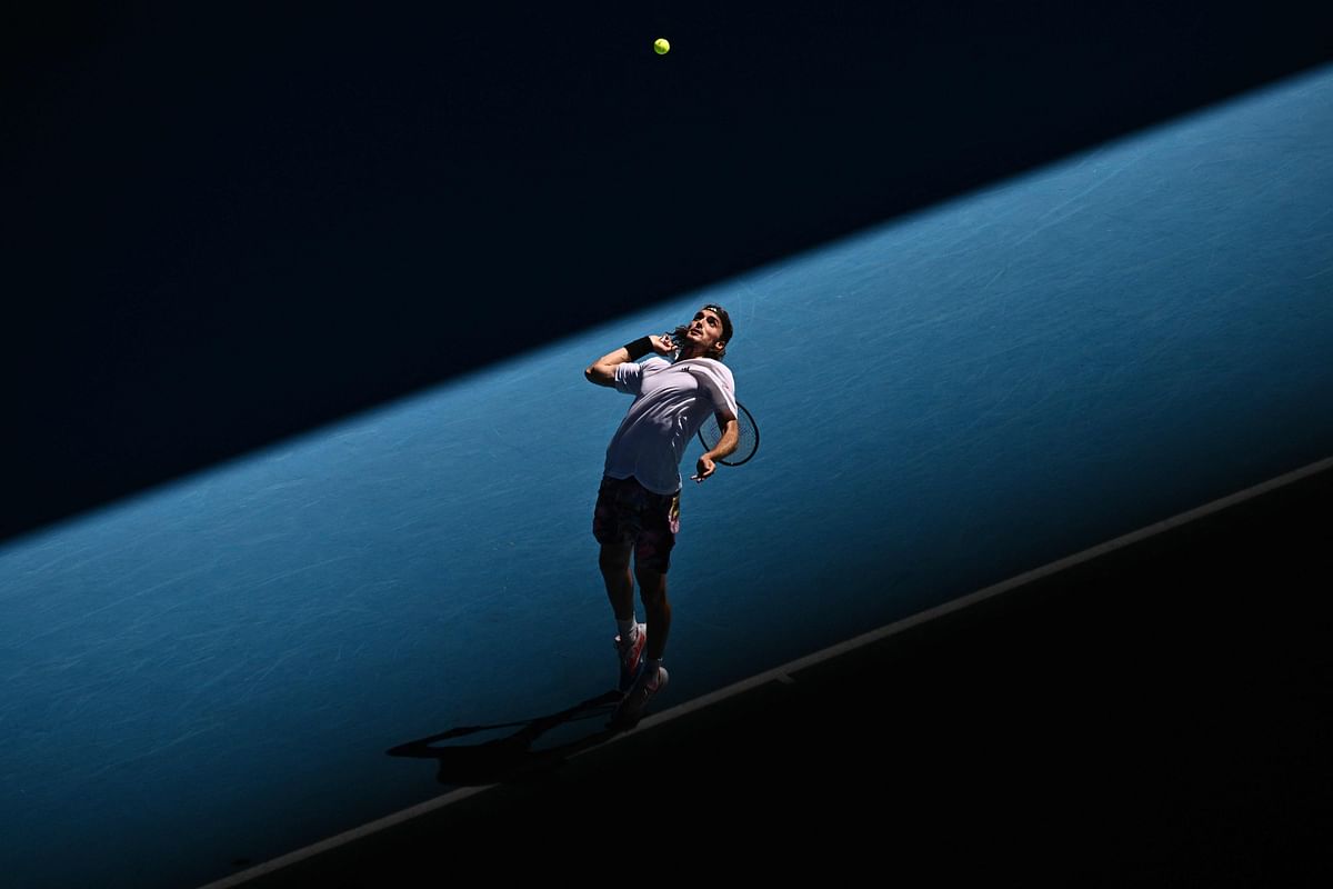 Greece's Stefanos Tsitsipas serves against Russia's Karen Khachanov during their men's singles semi-final match on day twelve of the Australian Open tennis tournament in Melbourne on January 27, 2023. Credit: AFP Photo