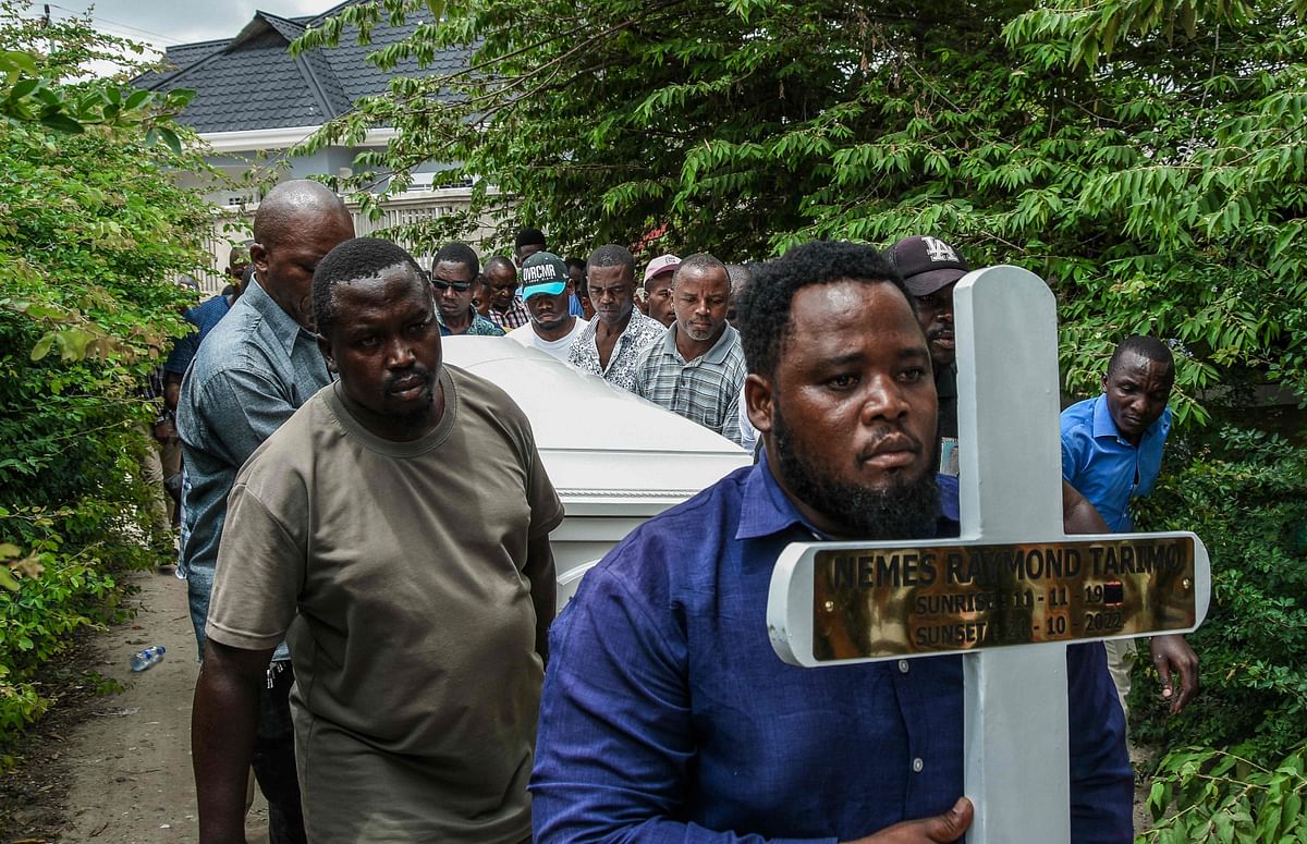 Mourners proceed bearing a cross and a coffin with the body of Tanzanian student, Nemes Tarimo, whose body arrived at his homeplace in Dar es Salaam, Tanzania, on January 27, 2023, after he was killed fighting for Russia in Ukraine after being recruited in jail. Credit: AFP Photo