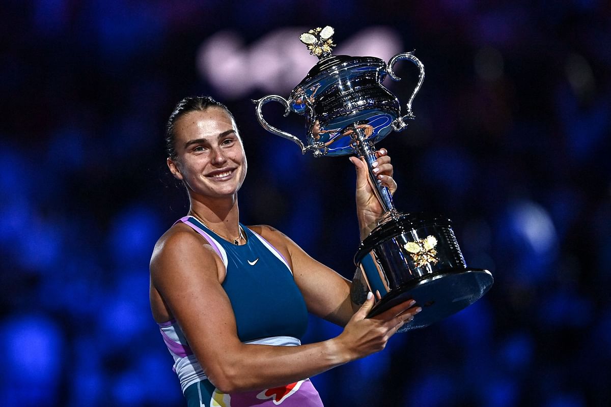 Belarus' Aryna Sabalenka celebrates with the Daphne Akhurst Memorial Cup after defeating Kazakhstan's Elena Rybakina in the women's singles final match on day thirteen of the Australian Open tennis tournament in Melbourne on January 28, 2023.  Credit: AFP Photo