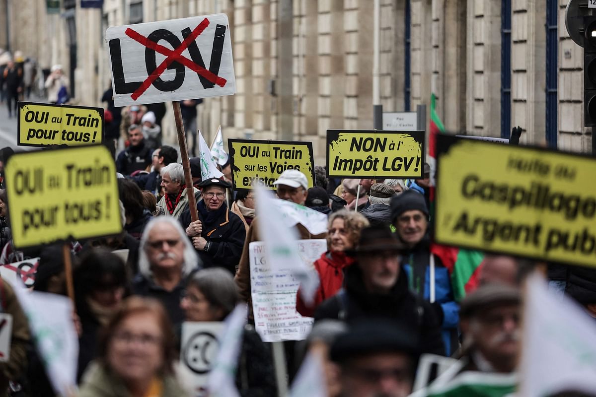 Protesters march towards the prefecture with placards during a rally called by local officials and officials, associations against the high-speed line (LGV) project linking Bordeaux to Toulouse, in Bordeaux on January 28, 2023. Credit: AFP Photo