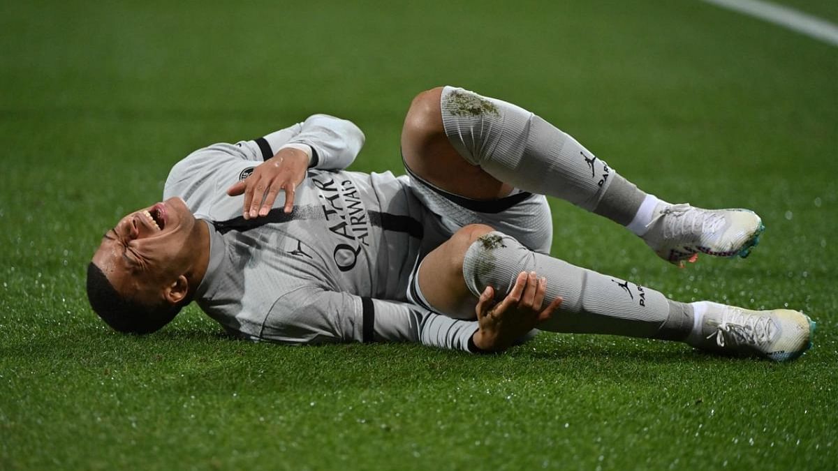 Paris Saint-Germain's French forward Kylian Mbappe lies on the ground after getting injured during the French L1 football match between Montpellier Herault SC and Paris Saint-Germain (PSG) at Stade de la Mosson in Montpellier. Credit: AFP Photo