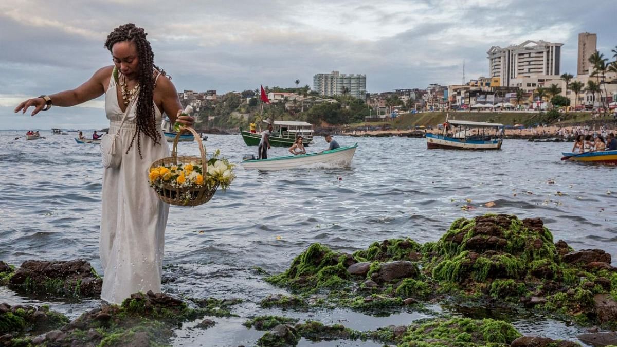 Worshippers take part in the traditional ceremony of Iemanja, the Goddess of the Sea of the syncretic Afro-Brazilian religion Umbanda at the Rio Vermelho neighborhood, in Salvador, Bahia, Brazil. Credit: AFP Photo