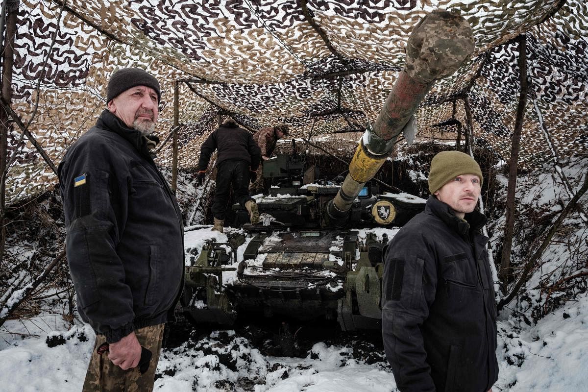 A Ukrainian serviceman of the first tank brigade Volodymyr (L), 57, who has worked as a tank driver, stands in front of his T-64 Main Battle Tank near the frontline in the Donetsk region. Credit: AFP Photo