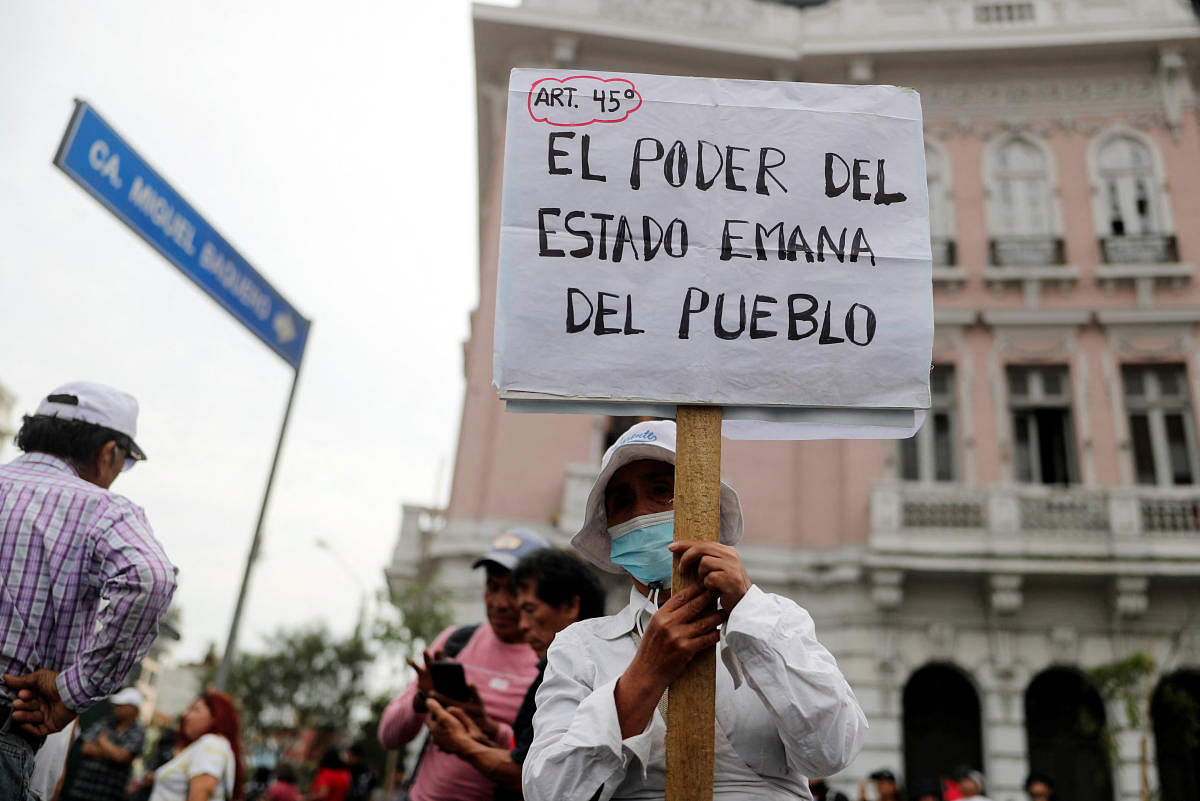 A demonstrator holds a sign that reads