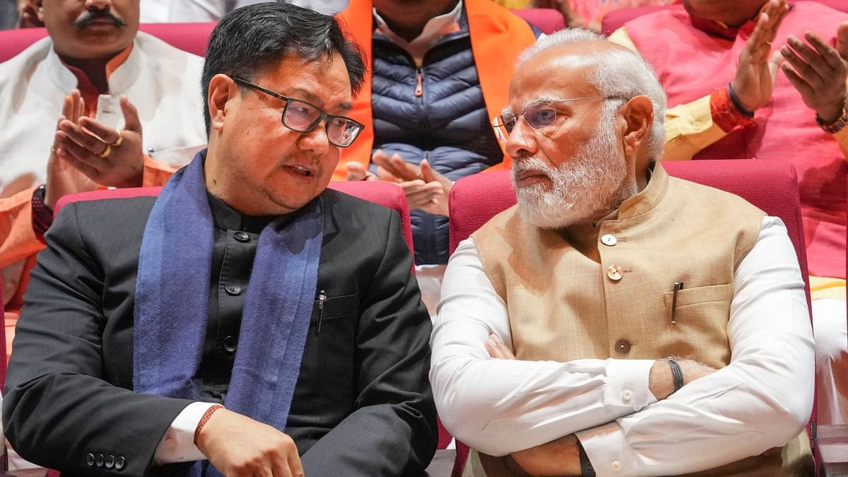 Prime Minister Narendra Modi in conversation with Union Law Minister Kiren Rijiju during the BJP Parliamentary Party meeting in New Delhi. Credit: PTI Photo