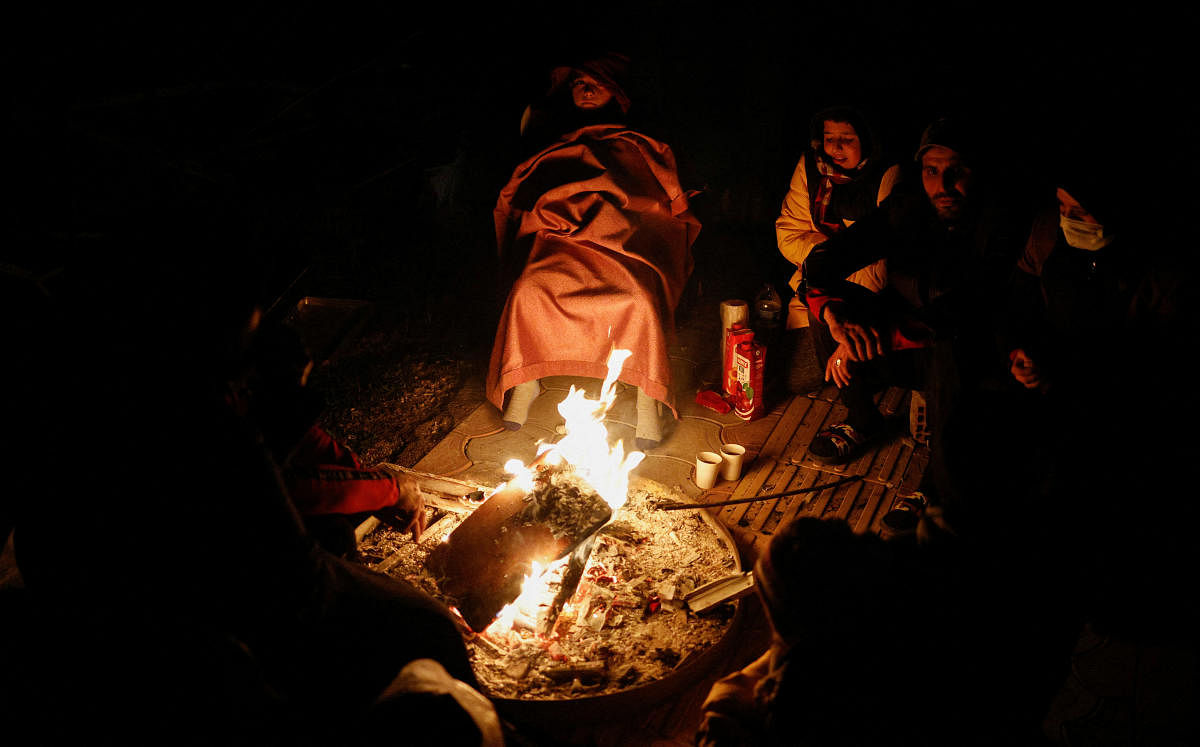 People warm up around a fire following an earthquake in Antakya, Hatay Province,Turkey. Credit: Reuters Photo
