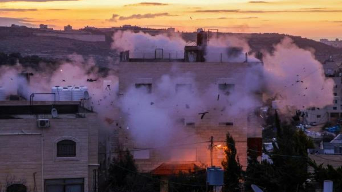 Smoke billows as the residence of Mohammad al-Jaabari, a Palestinian who carried out a shooting attack last year, is demolished by Israeli forces in Hebron in the occupied West Bank. Credit: AFP Photo