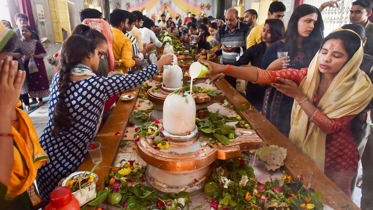 Devotees perform 'abhishek' of Lord Shiva on the occasion of 'Maha Shivratri', at a temple in Prayagraj. Credit: PTI Photo