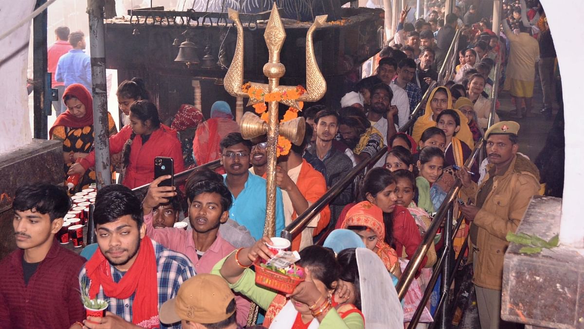 Devotees wait in queues to offer prayers at Anandeshwar temple on the occasion of 'Maha Shivratri', in Kanpur. Credit: PTI Photo