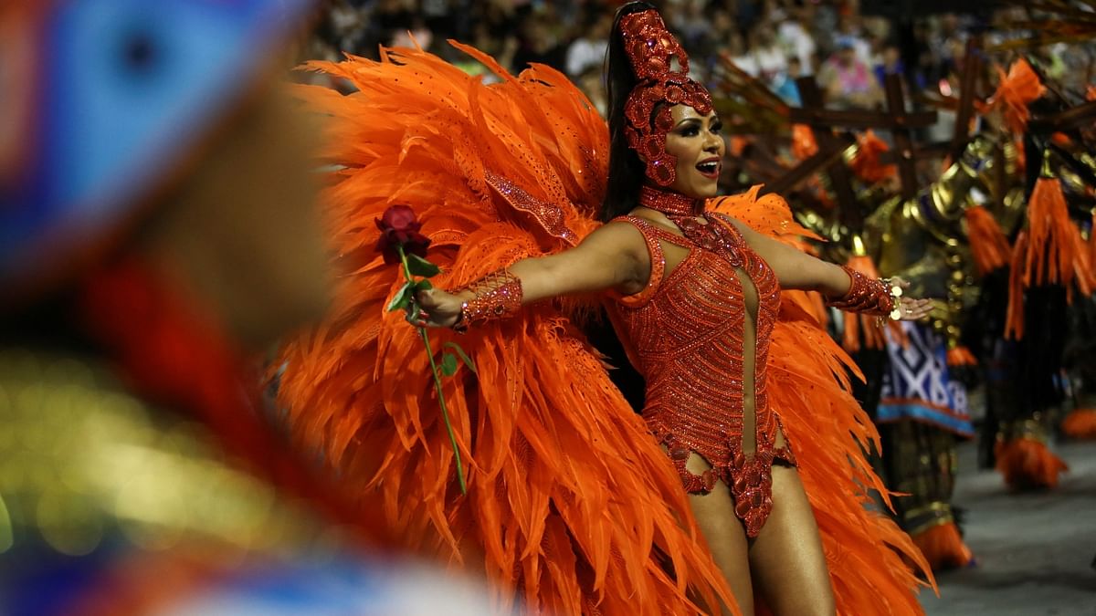 A reveller in orange attire performs during the first night of the Carnival parade at Anhembi Sambadrome in Sao Paulo, Brazil. Credit: Reuters Photo