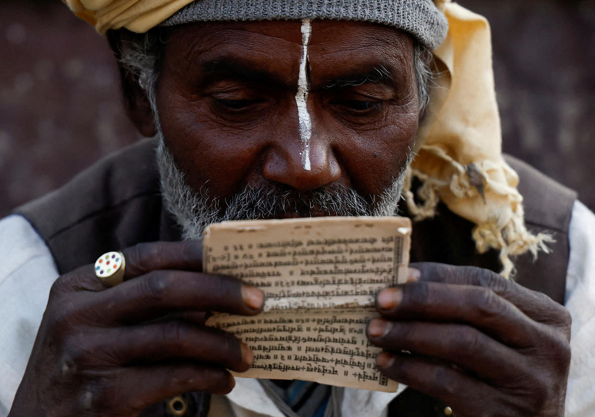 A Hindu holy man, or sadhu, reads a holy book at the premises of Pashupatinath Temple during the Shivaratri festival in Kathmandu, Nepal. Credit: Reuters Photo