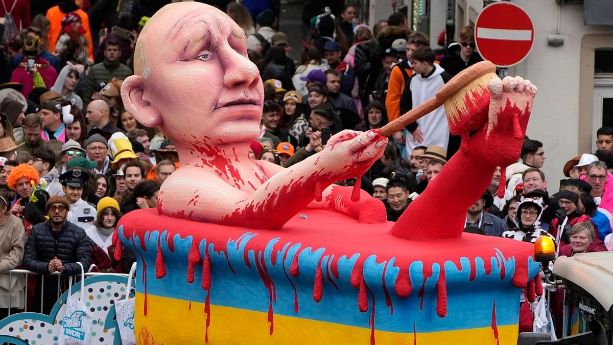 A carnival float depicted Russia's President Vladimir Putin taking a blood bath in a tub in the colours of Ukraine's flag during the traditional carnival parade in Duesseldorf, Germany. Outrage at Russia's invasion of Ukraine was a recurring theme in the carnival parades around Germany on Rose Monday. Credit: AP Photo