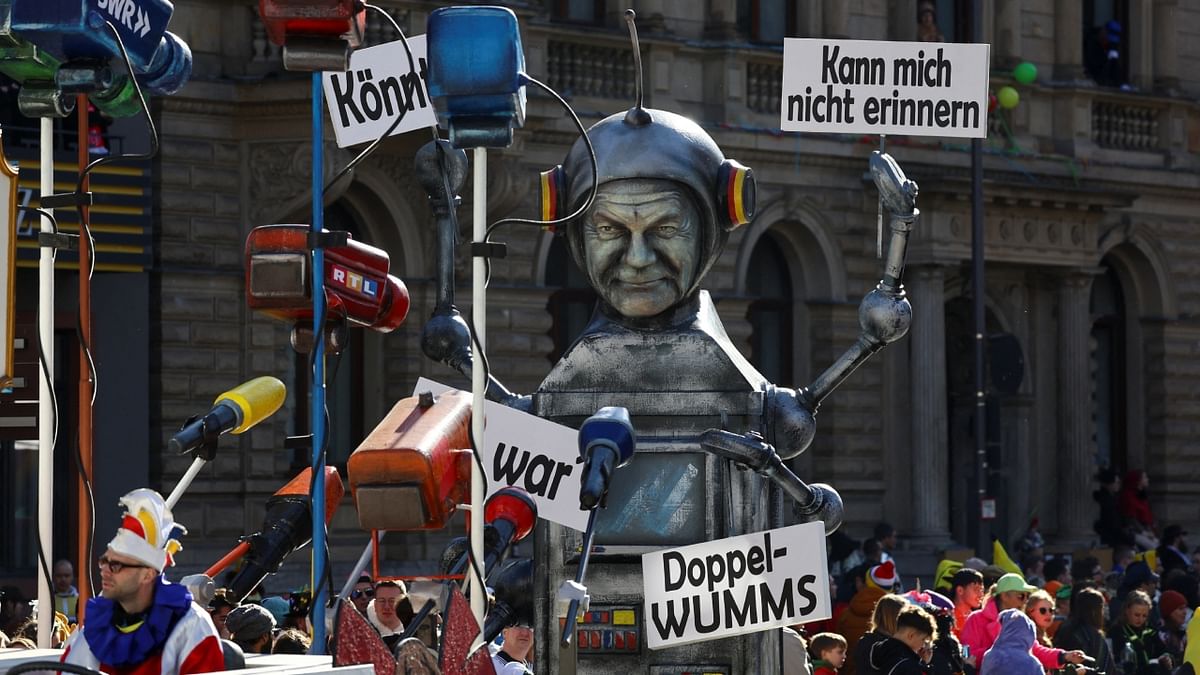 A robot with German Chancellor Olaf Scholz's face attending a press conference holding placards with some of his famous one-line quotes of recent times was one of the floats that turned many heads. Credit: Reuters Photo