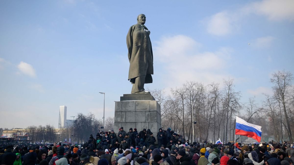 People gather near a monument to the founder of the Soviet Union Vladimir Lenin as they arrive for a patriotic concert dedicated to the upcoming Defender of the Fatherland Day at the Luzhniki stadium in Moscow on February 22, 2023. Credit: AFP Photo