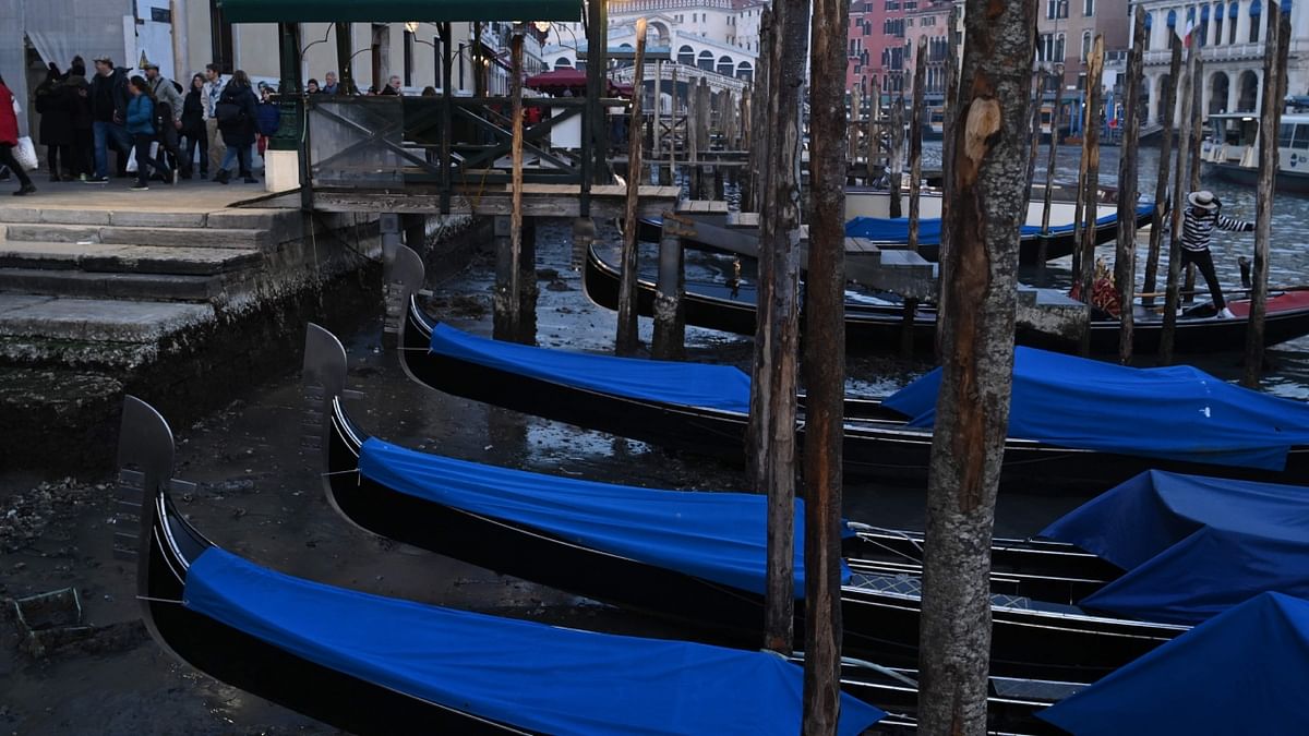 Gondolas lay beached along a series of Venice's famed canals amid low tides and lack of rain. Credit: AFP Photo