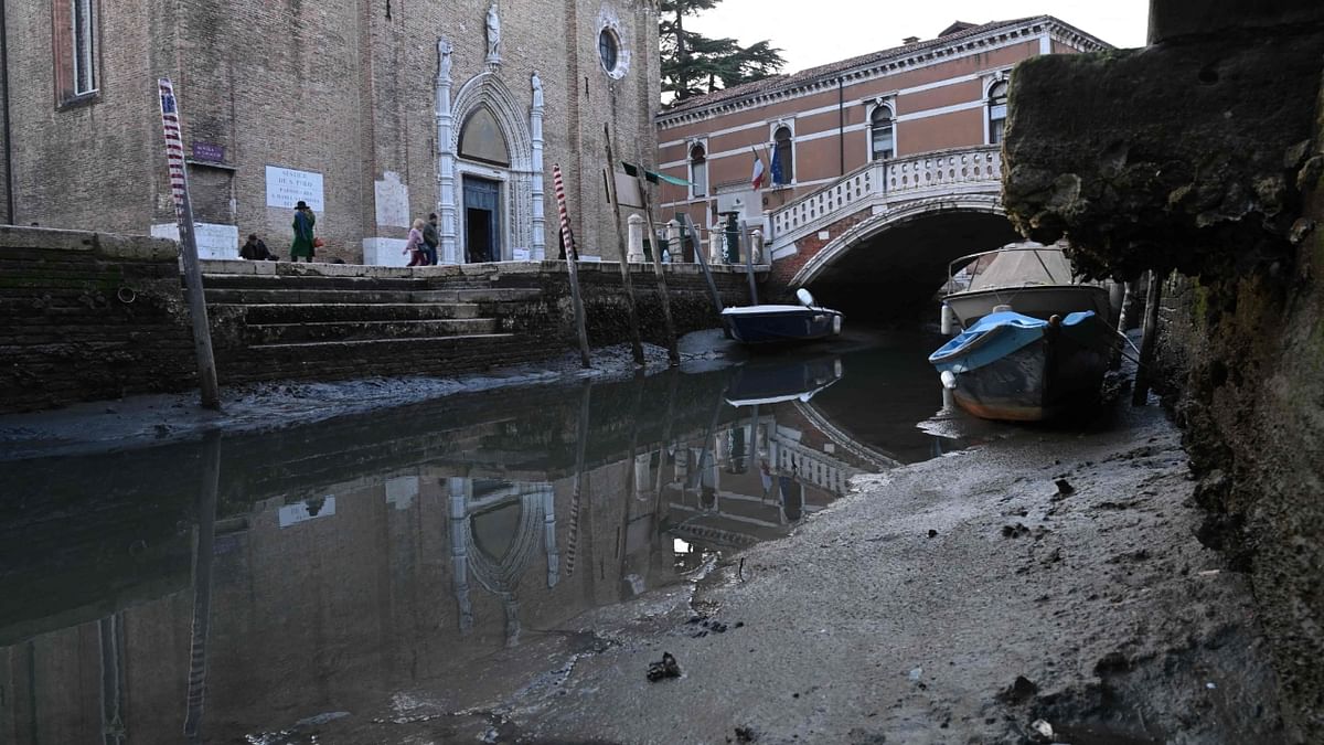 Ambulance boats in some cases have had to tie up farther from their destination, forcing medical crews to sometimes hand carry stretchers over long distances since their vessels can't progress up canals reduced to a trickle of water and muck. Credit: AFP Photo