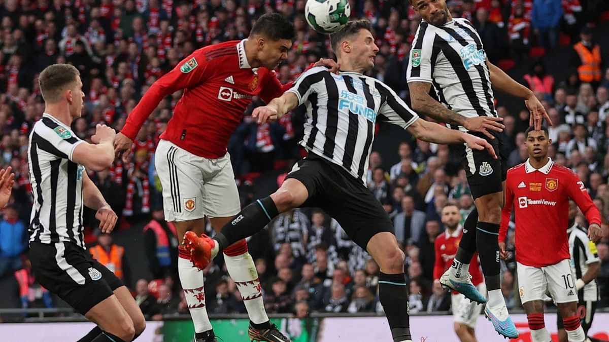 Manchester United's Brazilian midfielder Casemiro (2L) heads home the opening goal of the English League Cup final football match between Manchester United and Newcastle United at Wembley Stadium, north-west London on February 26, 2023. Credit: AFP Photo