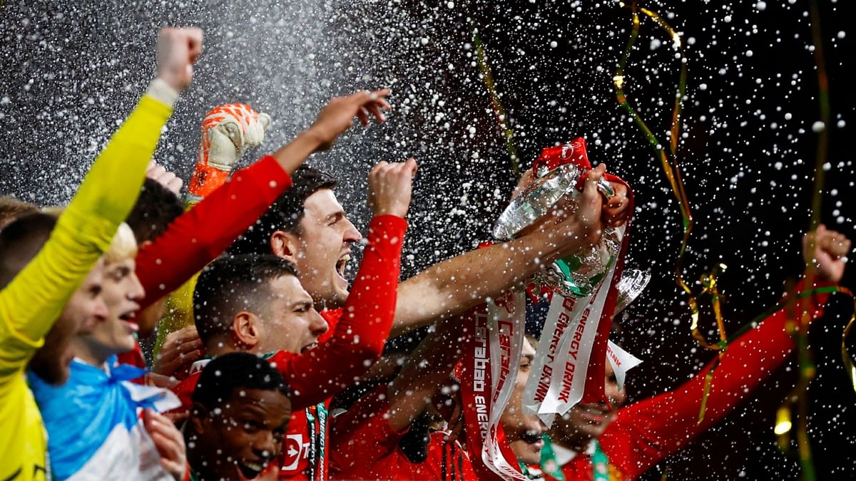 Manchester United's Harry Maguire lifts the trophy with teammates after winning the Cup. Credit: Reuters Photo