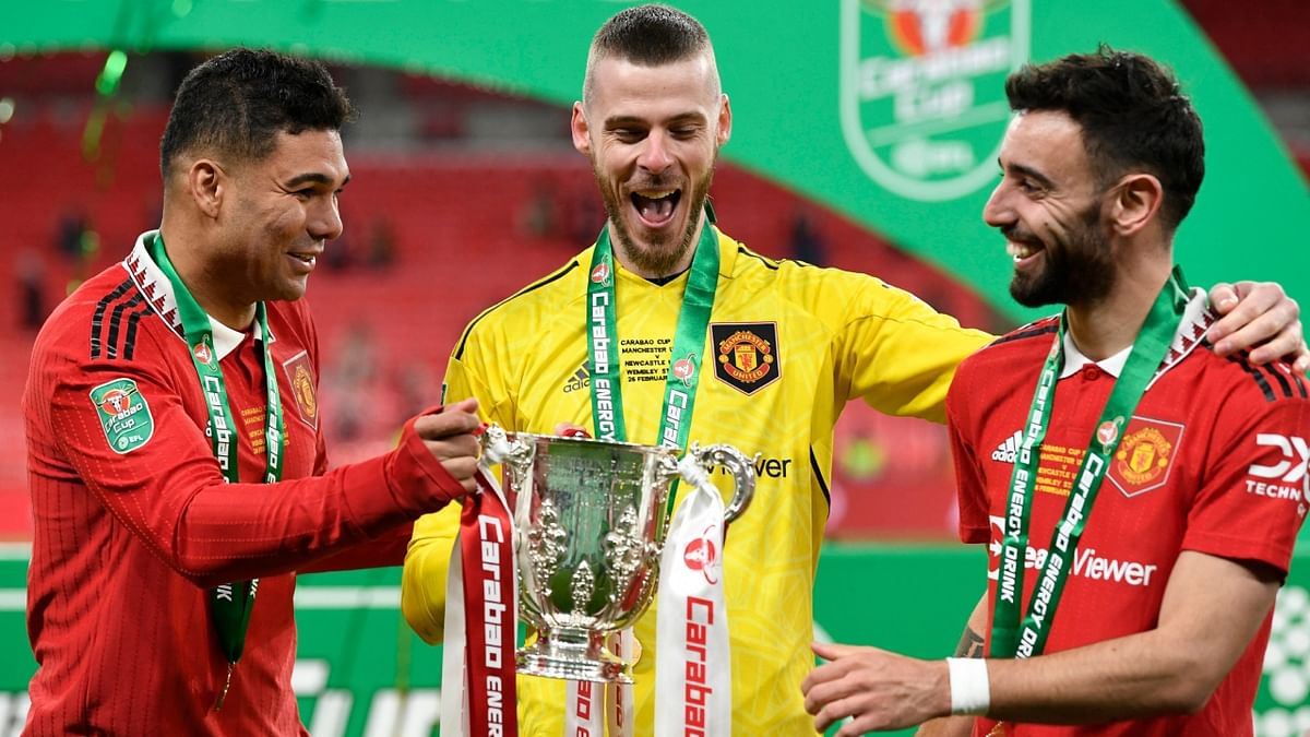 Manchester United's Casemiro, David de Gea and Bruno Fernandes celebrate with the trophy after winning the Carabao Cup. Credit: Reuters Photo
