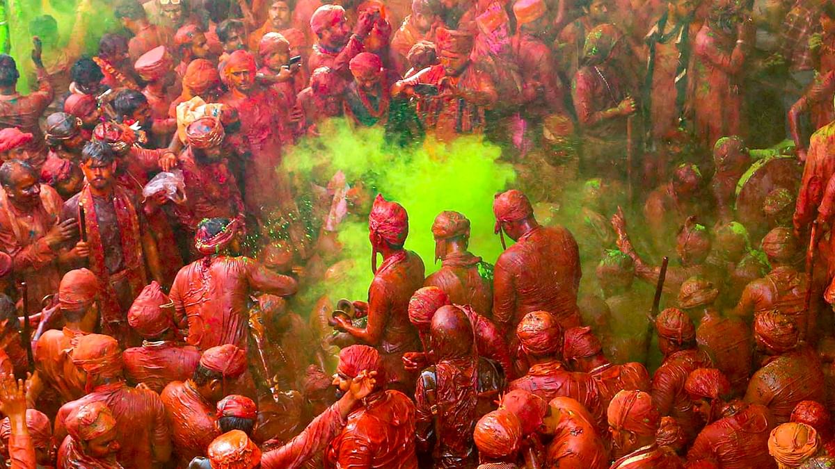 People daubed in colours during 'Lathmar Holi' celebrations at Sriji Temple in Barsana town near Mathura. Credit: PTI Photo