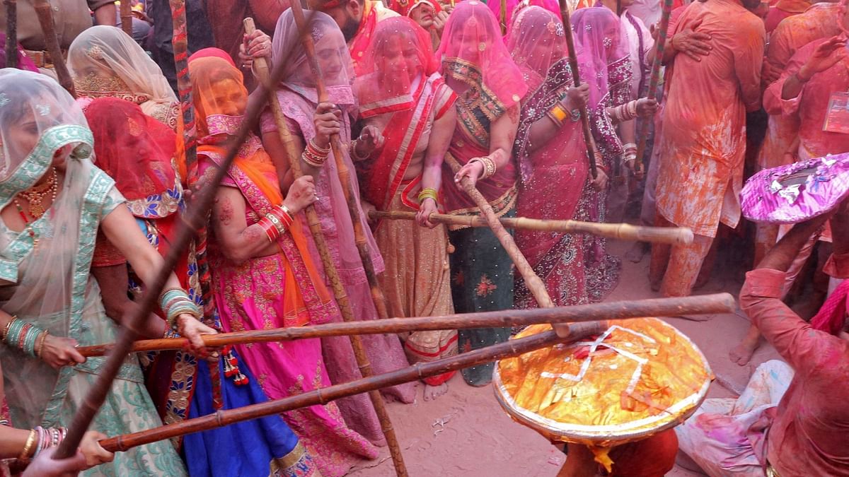 Women hit revellers with sticks as a traditional practice during the Lathmar Holi celebrations in Uttar Pradesh. Credit: AFP Photo