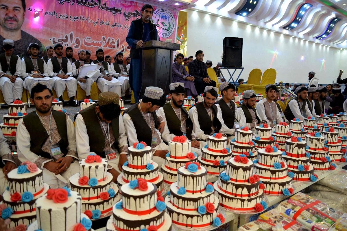 Afghan grooms attend their mass wedding ceremony at a hall in Kandahar. Credit: AFP Photo