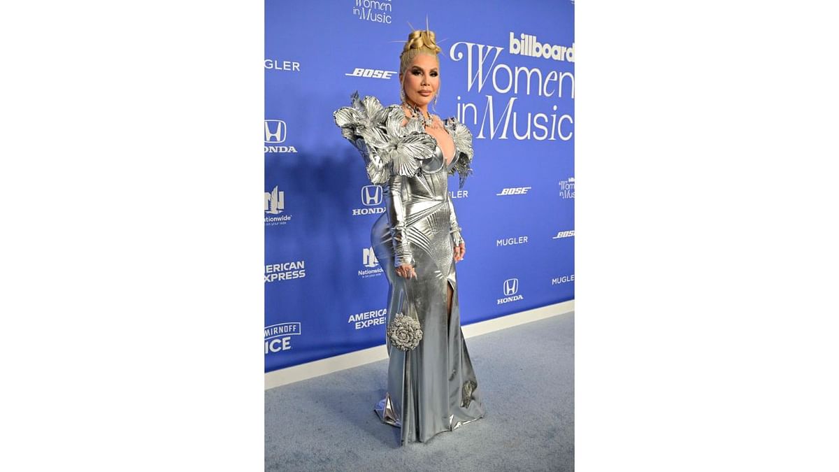 Dazzling in an all-silver, body-hugging gown, Puerto Rican singer Ivy Queen was one of the best-dressed stars at the Billboard Women In Music 2023. Credit: AFP Photo