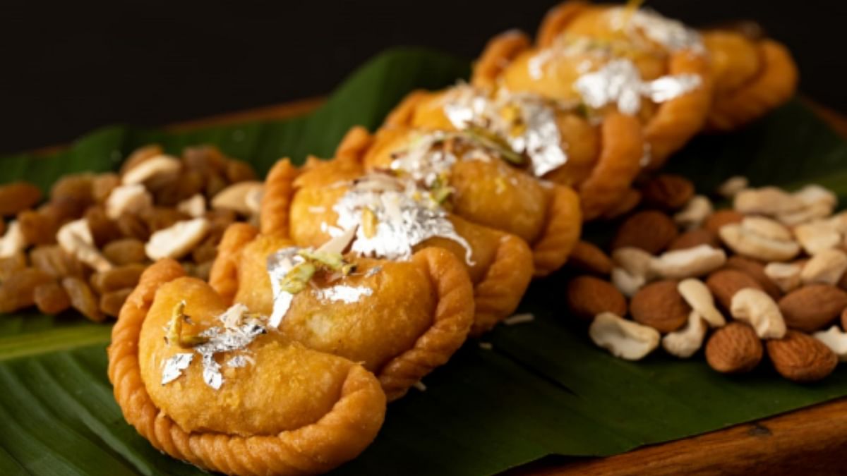 'Gujiya' is a traditional local Indian sweet and is in good demand during Holi. 'Gujiya' is prepared with 'maida' stuffed with 'mava' or 'khoya' and dry fruits. It is fried and then dipped in sugar syrup. Credit: DH Pool Photo