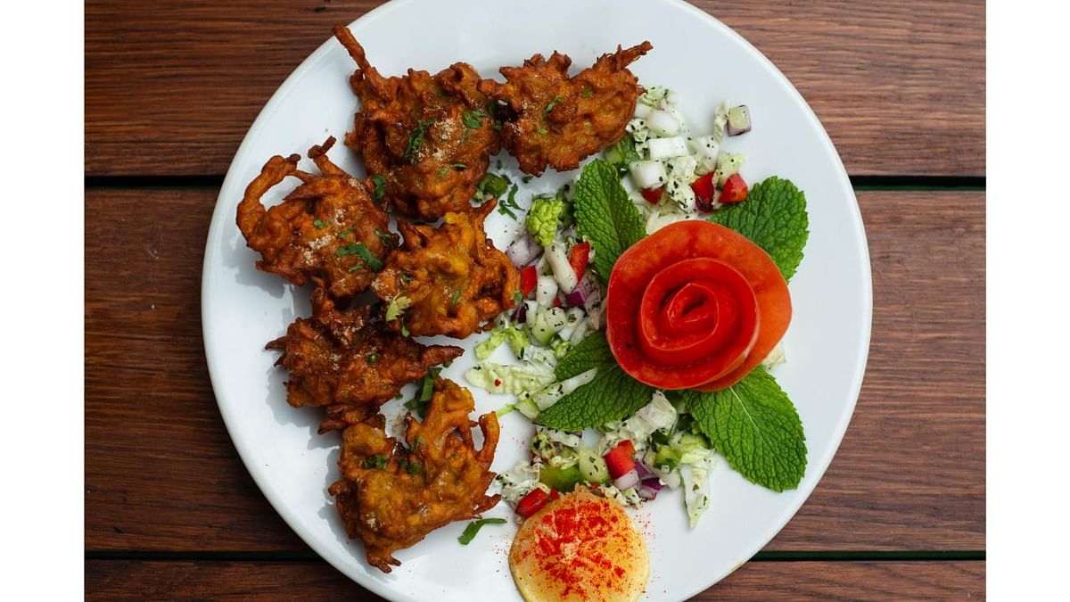 'Pakoras' are crispy fritters made with onions, potatoes, gram flour, spices and herbs. One can elevate the festive spirit by adding the special mascot herb of Holi - Bhang. Credit: DH Photo