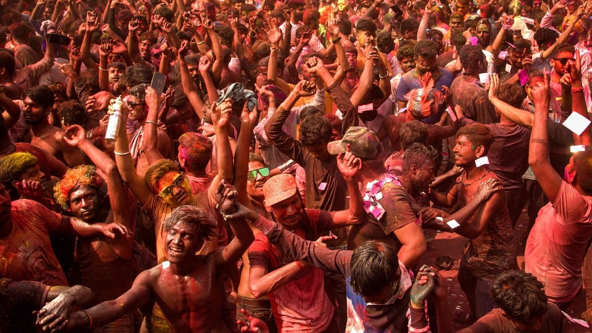 Revelers smeared with 'Gulal' celebrate the spring festival of colours, Holi, in Guwahati. Credit: AFP Photo