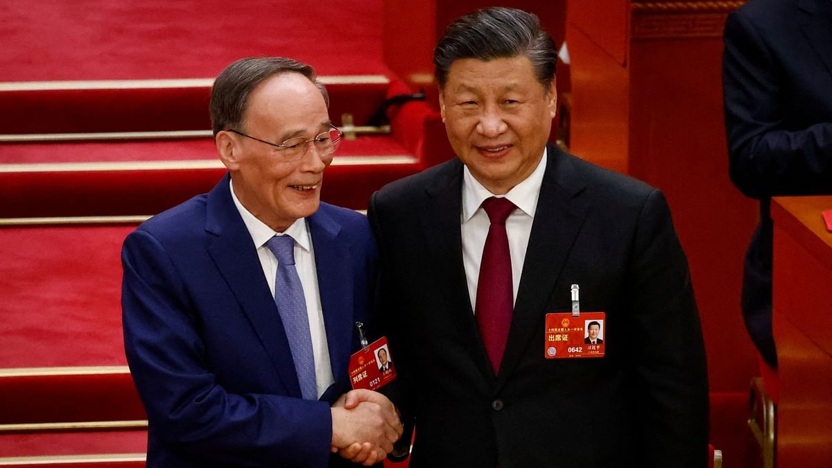 Chinese President Xi Jinping shakes hands with Vice President Wang Qishan during the Third Plenary Session of the National People's Congress (NPC) at the Great Hall of the People, in Beijing. Credit: Reuters Photo