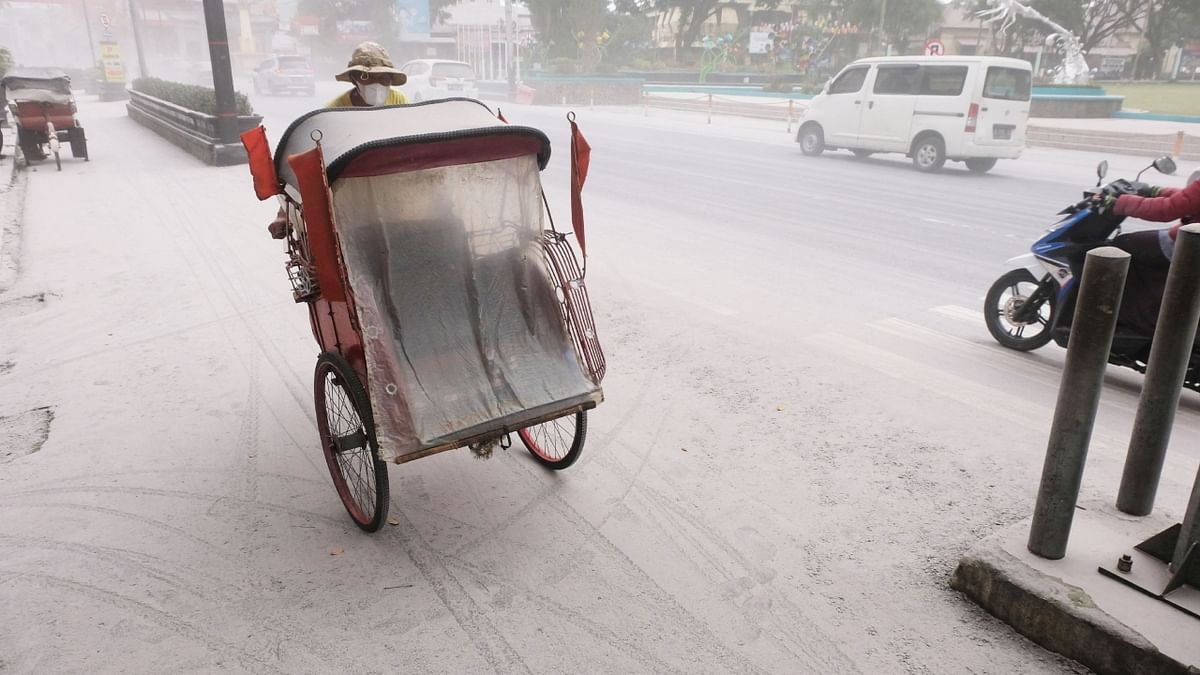 A pedicab passes on a road covered in ash from the eruption of Indonesia's Mount Merapi, in Magelang, Indonesia. Credit: Reuters Photo