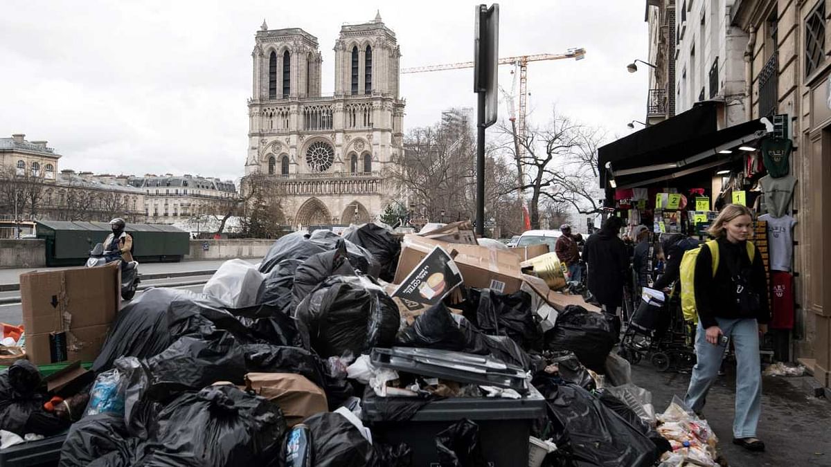 Household waste near the Notre-Dame cathedral, that has been piling up on the pavement as waste collectors are on strike since March 6 against the French government's proposed pensions reform. Credit: AFP Photo