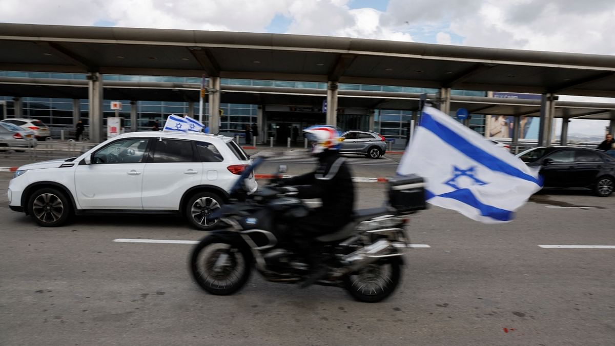 A convoy of bikes and cars bearing Israeli flags ply between the terminals at Ben Gurion International Airport during a protest PM Netanyahu. Credit: Reuters Photo