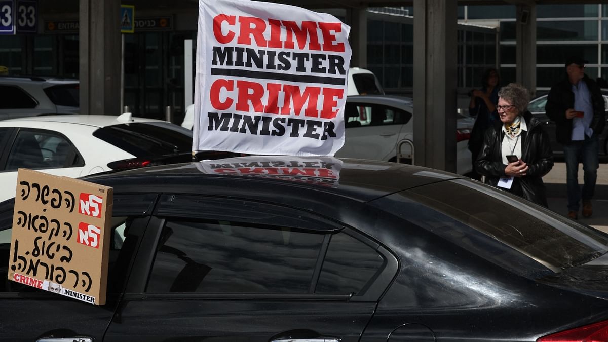 At Ben Gurion airport near Tel Aviv, some demonstrators also held aloft banners that read 'Crime Minister', in reference to Netanyahu's ongoing legal battle. Credit: AFP Photo