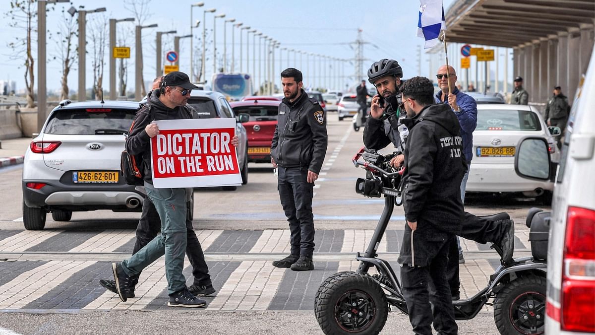 'Dictator on the run' and 'Don't come back', read placards held up by demonstrators near the airport, where a convoy of cars bearing Israeli flags circulated between the terminals, making them difficult to access. Credit: AFP Photo