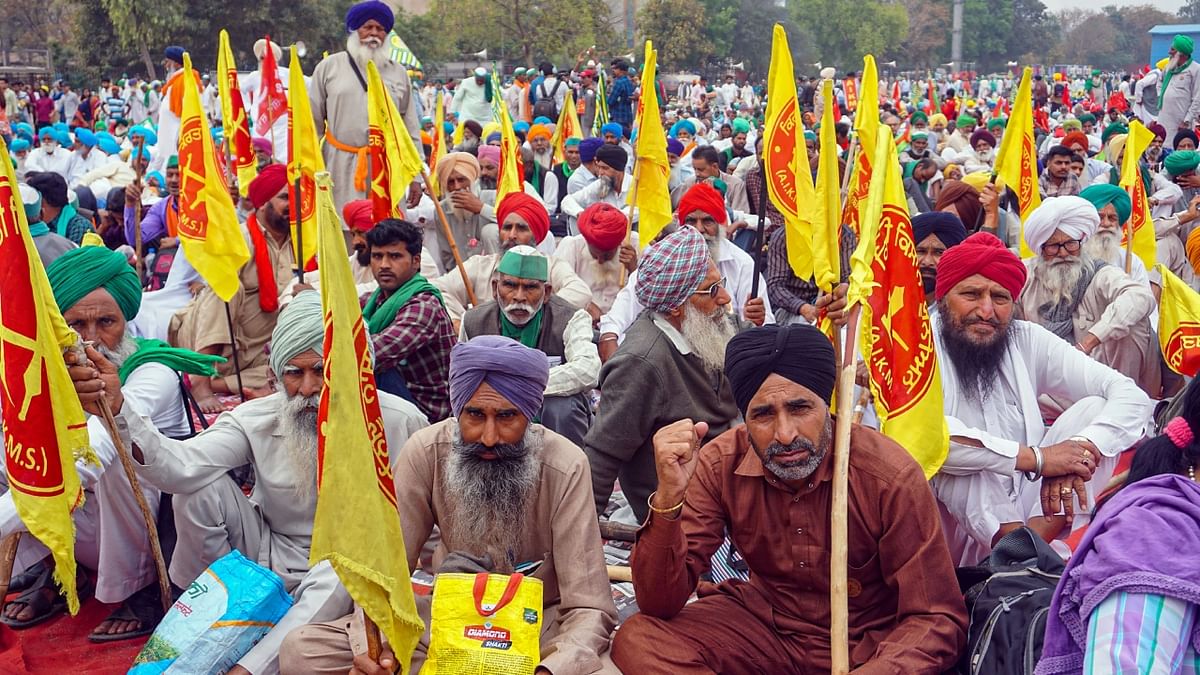 Farmers get clicked during the Kisan Mahapanchayat organised at Ramlila Maidan in New Delhi. Credit: PTI Photo