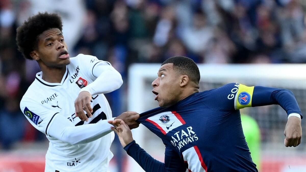 Rennes' French defender Warmed Omari (L) pulls jersey of Paris Saint-Germain's French forward Kylian Mbappe during the French L1 football match between Paris Saint-Germain (PSG) and Stade Rennais FC. Credit: AFP Photo