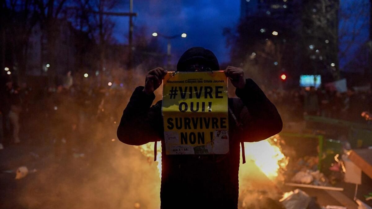 A protesters holds a placard that reads