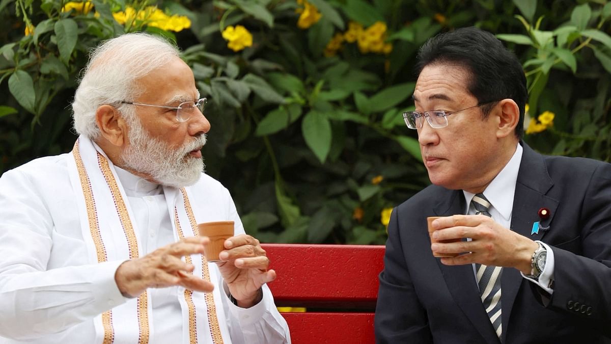 Prime Minister Narendra Modi and Japanese PM Fumio Kishida enjoy a drink as they interact at Buddha Jayanti Park in New Delhi. Credit: PTI Photo