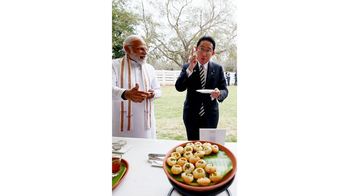 Prime Minister Narendra Modi and Japanese PM Fumio Kishida enjoy tangy golgappas at Buddha Jayanti Park in New Delhi. Credit: PTI Photo