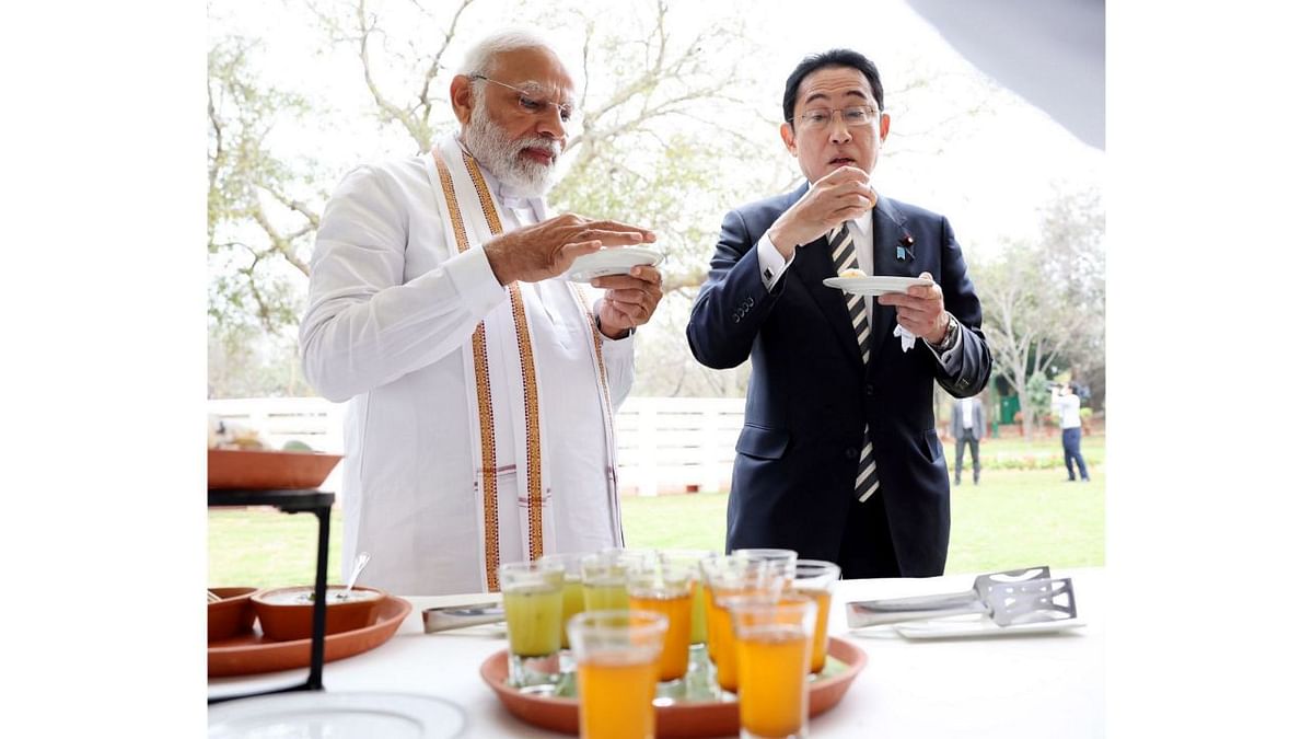 The picture shows PM Modi and Kishida conversing over golgappas. Credit: PTI Photo