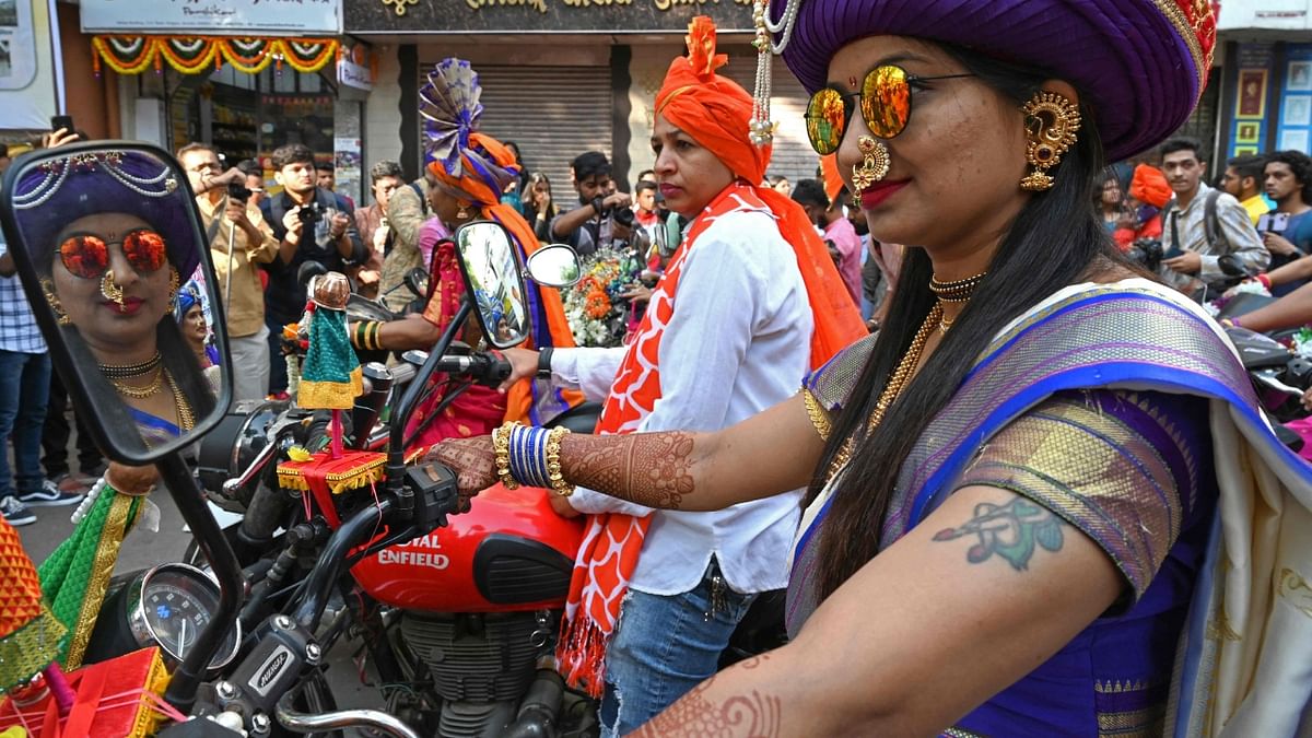 Women bikers dressed in a traditional attire take part in the celebrations. Credit: AFP Photo