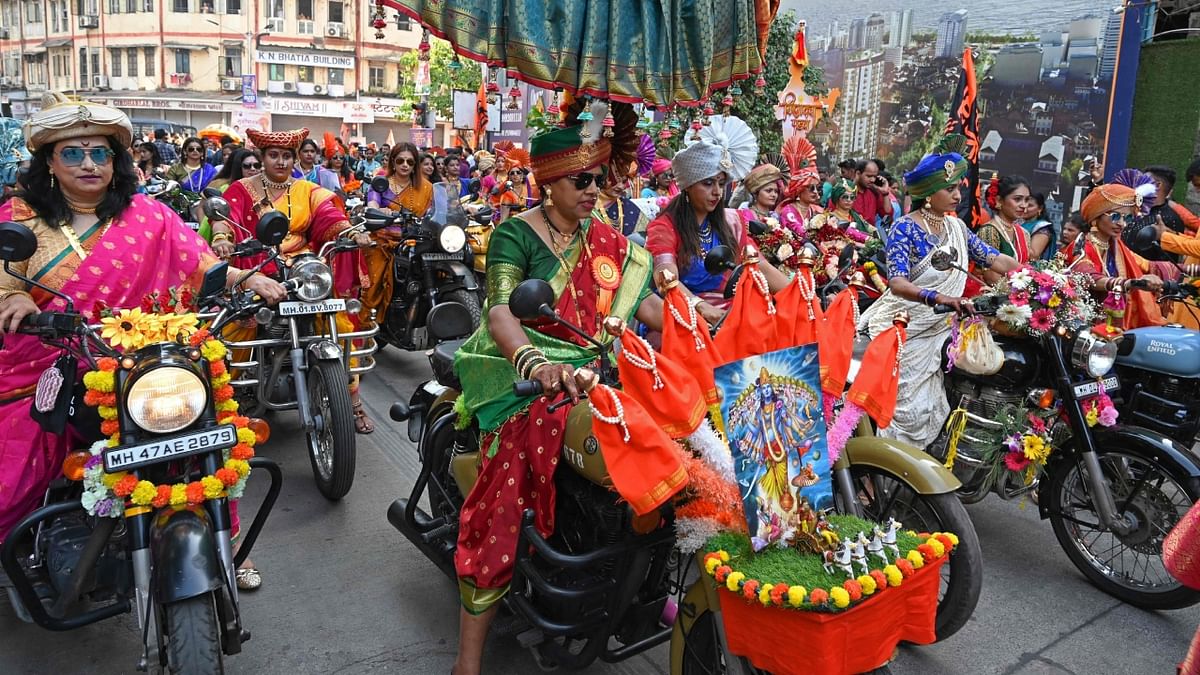 The Gudi Padwa festival is being celebrated with enthusiasm and pomp in Maharashtra with women dressed in traditional Nauvari saris taking out a bike rally on the streets of Girgaum on March 22. Credit: AFP Photo