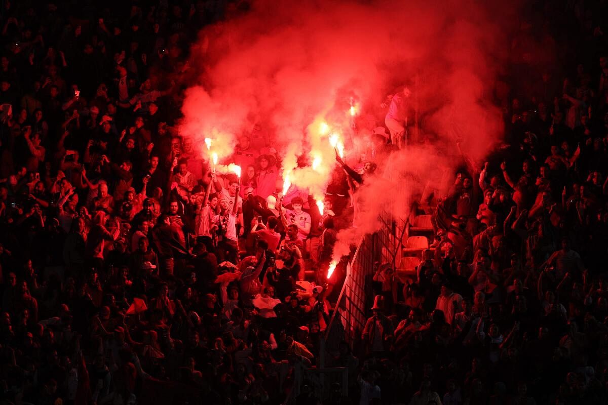 Morocco supporters wave flares during a friendly football match between Morocco and Brazil at the Ibn Batouta Stadium in Tangier. Credit: AFP Photo