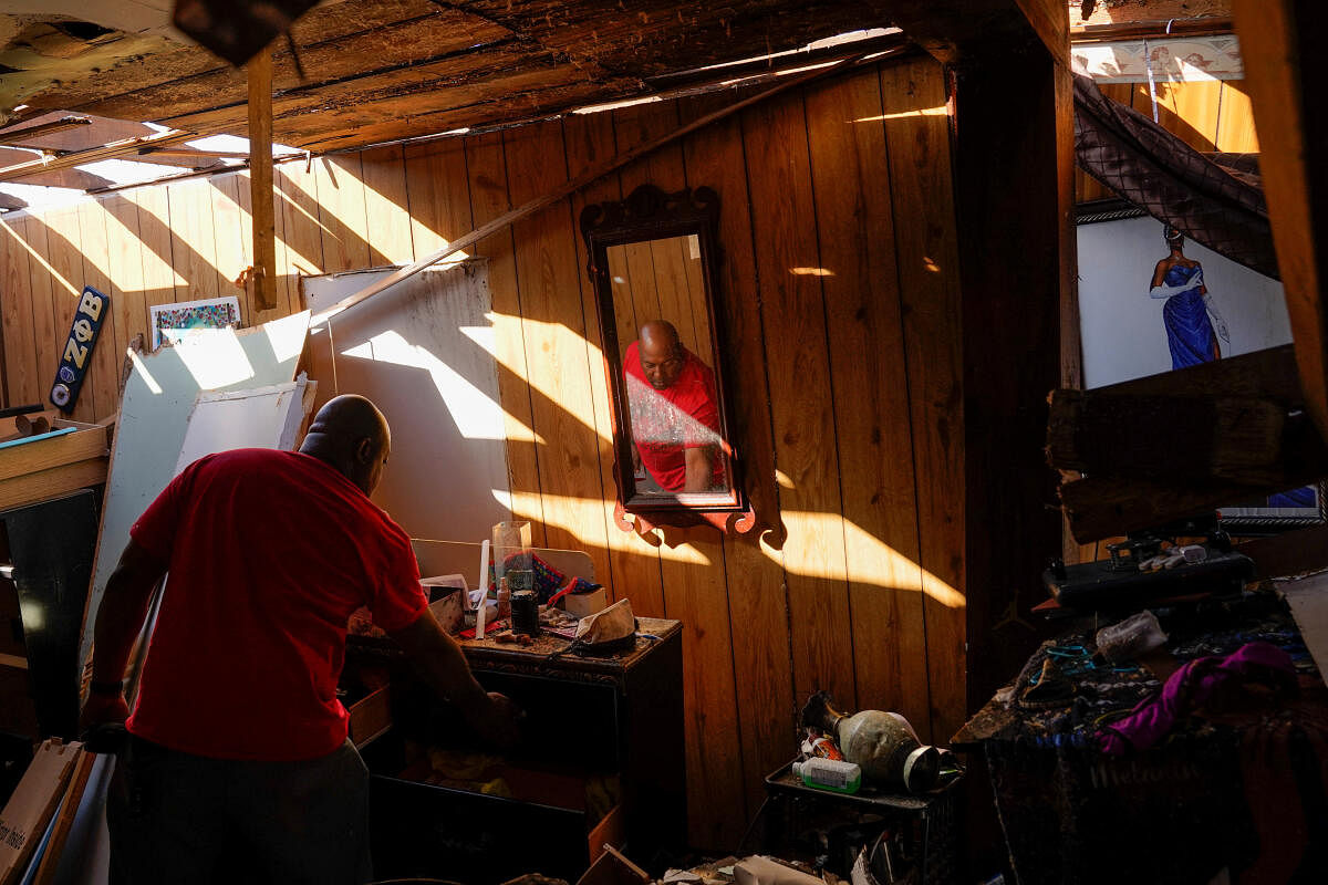 Cedric Miles, 42, searches for belongings inside his destroyed home after thunderstorms spawning high straight-line winds and tornadoes ripped across the state in Rolling Fork, Mississippi. Credit: reuters Photo