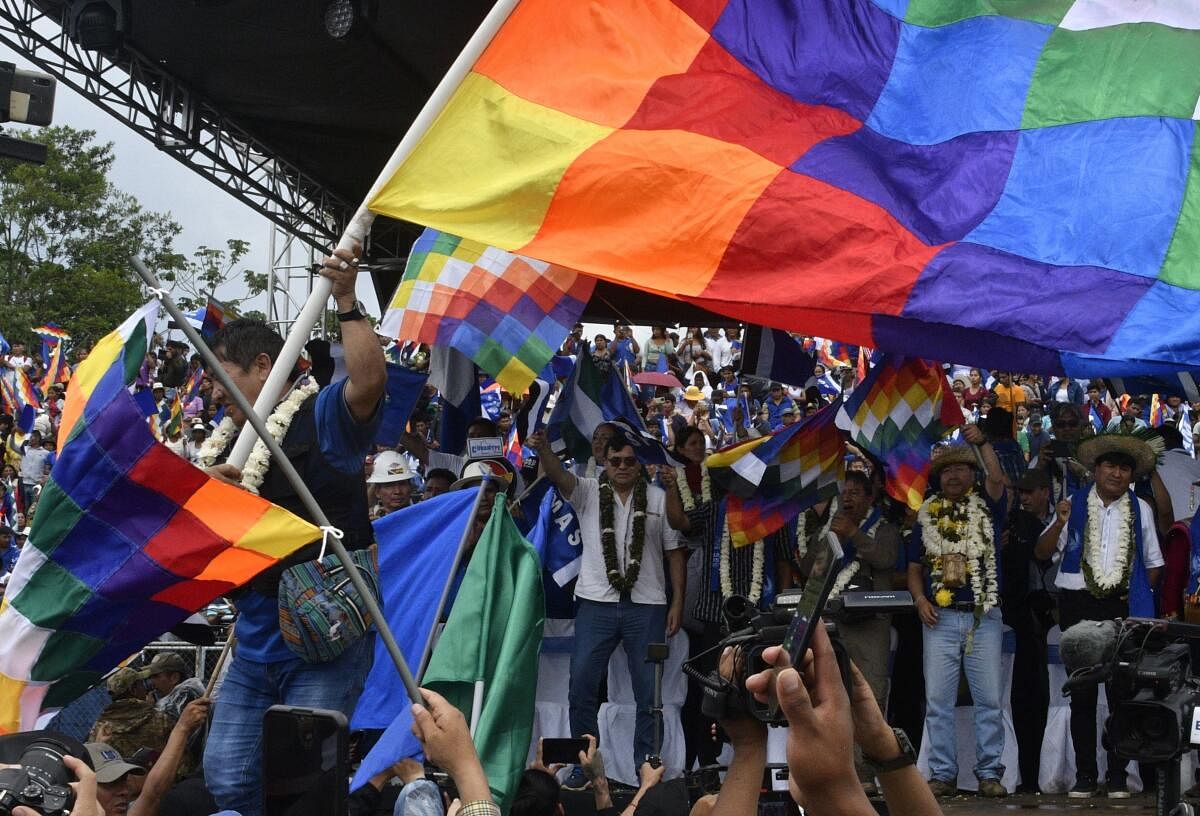 Bolivia's president Luis Arce (2-R) and ex-president (2006–2019) Evo Morales (R) attend a political gathering to mark the 28th anniversary of the ruling Movement for Socialism (MAS) party. Credit: AFP Photo