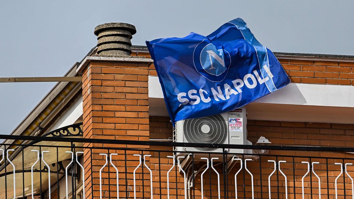 A fan's flag of the SSC Napoli football club flutters from a balcony on March 30, 2023 in Rome. - An incredible 19 points clear at the top of Serie A with 11 matches remaining, it's surely only a matter of time until southern Italy's biggest club win the Scudetto for the first time since 1990, when Diego Maradona was still strutting his stuff in sight of Mount Vesuvius. Credit: AFP Photo