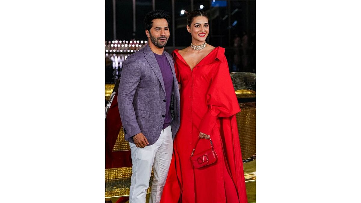 Varun Dhawan and Kriti Sanon posed together as Dhawan opted for shares of purple while Kriti went all red. Credit: PTI Photo