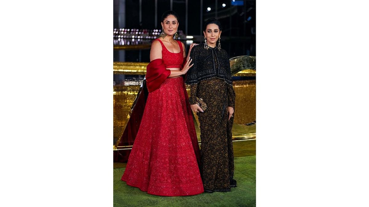 Celebrity siblings Kareena Kapoor and Karisma Kapoor like many others opted to go traditional. Kareena donned a red lehenga while Karishma wore a saree. Credit: PTI Photo
